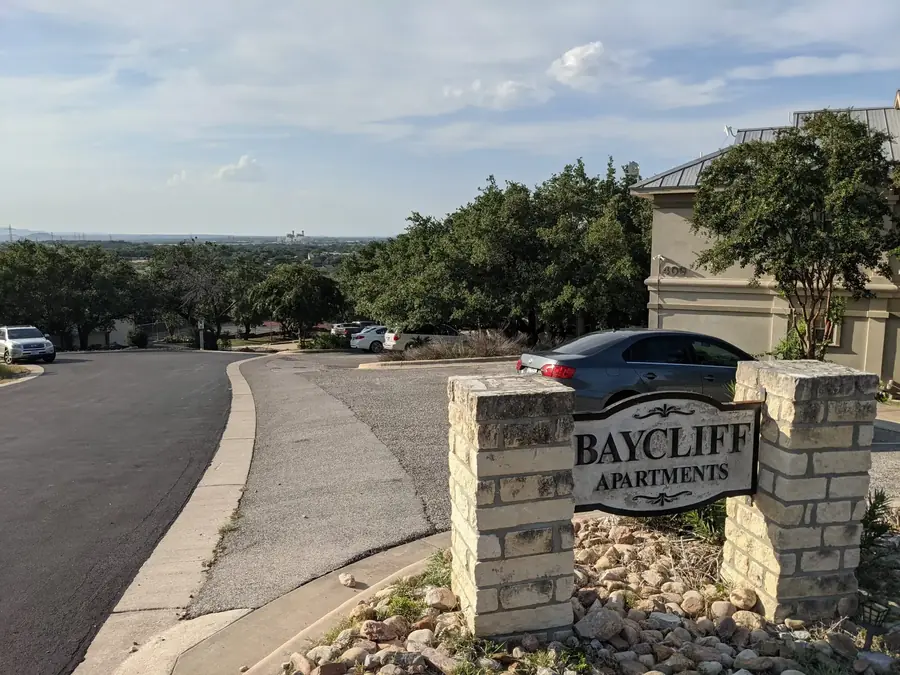 Baycliff Apartments stone entrance sign with Hill Country views