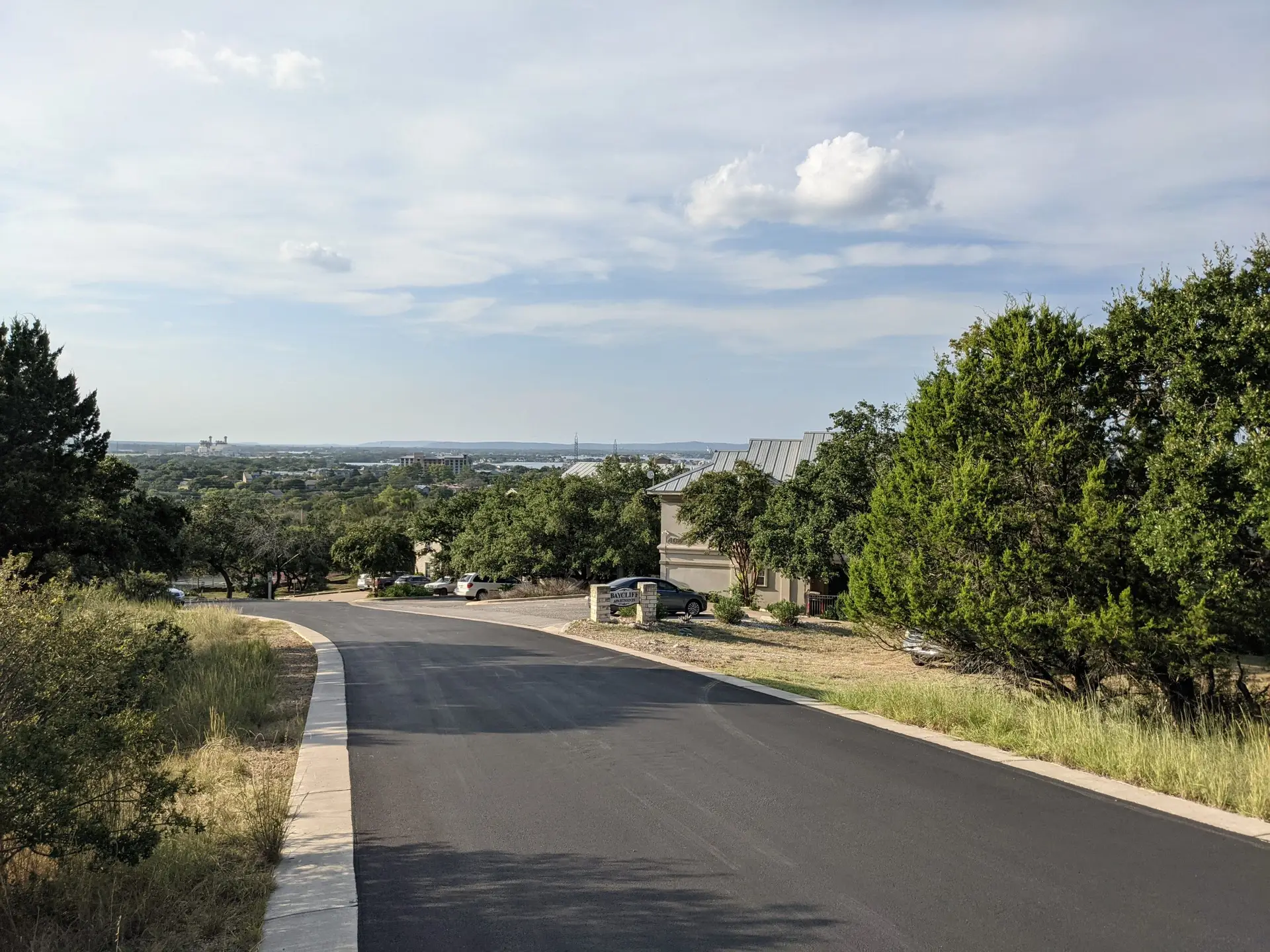 Driveway approach to Baycliff Apartments with Hill Country views