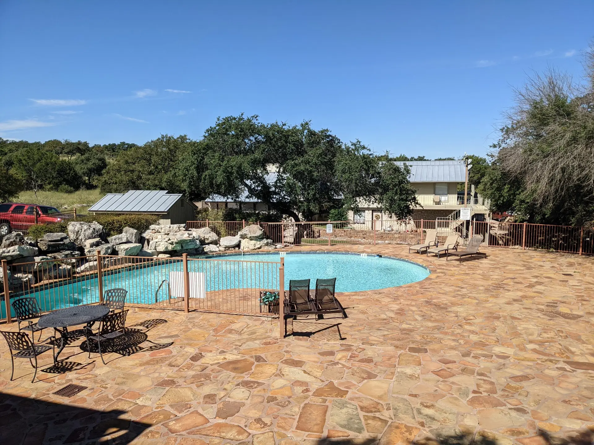 Baycliff pool deck with lounge chairs and stone patio