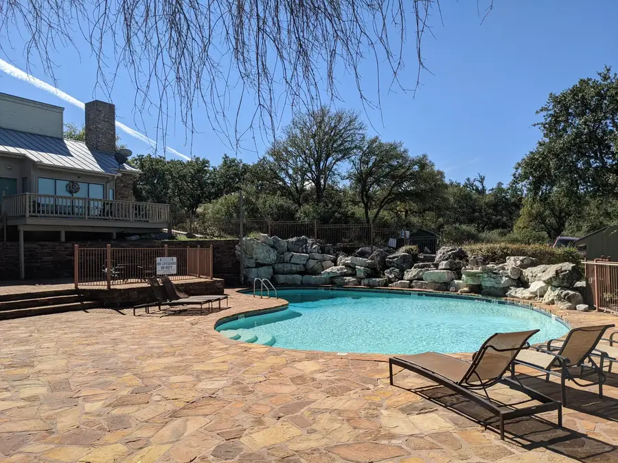 Baycliff resort-style pool with stone patio and lounge chairs