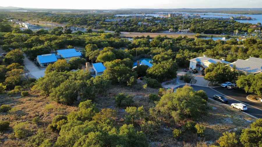 Wide aerial over Baycliff Apartments looking out to Lake LBJ, Horseshoe Bay TX
