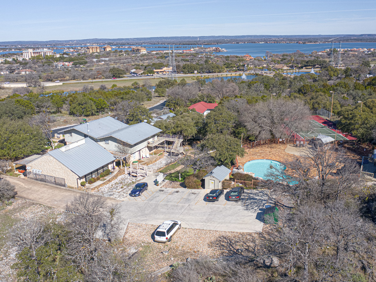 Aerial view showing Baycliff buildings, pool, tennis court and Lake LBJ