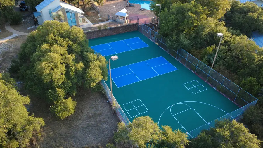 Aerial view of two resurfaced pickleball courts and half basketball court at Baycliff Apartments