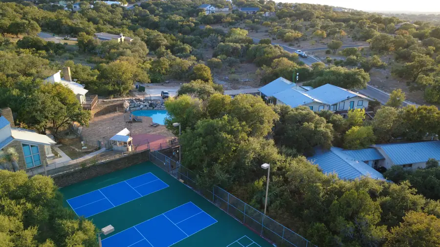 Baycliff pickleball courts framed by Texas Hill Country oaks at golden hour