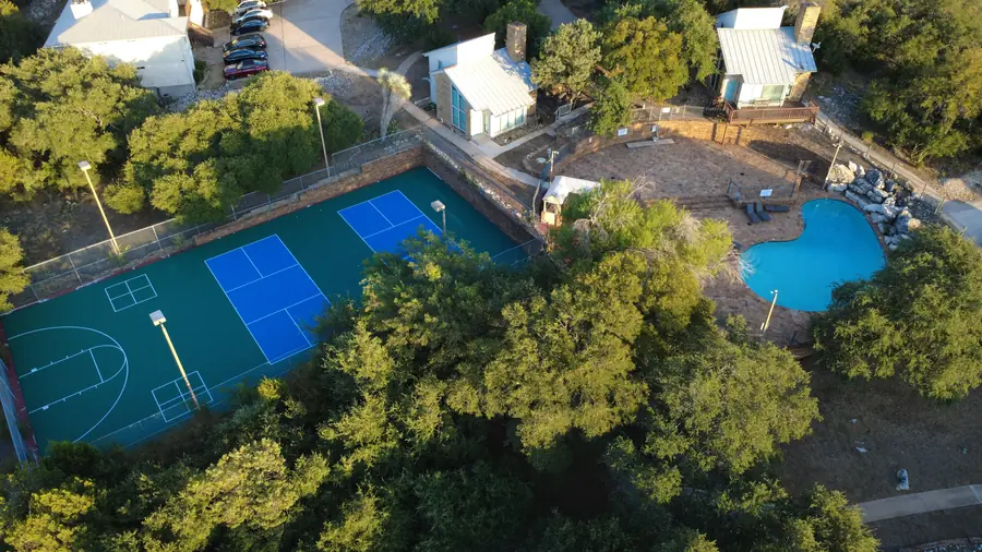 Baycliff pickleball courts directly beside the resort-style pool and patio