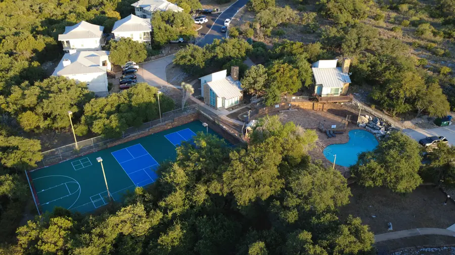 Baycliff amenity area showing pool, patio, pickleball courts and apartment buildings