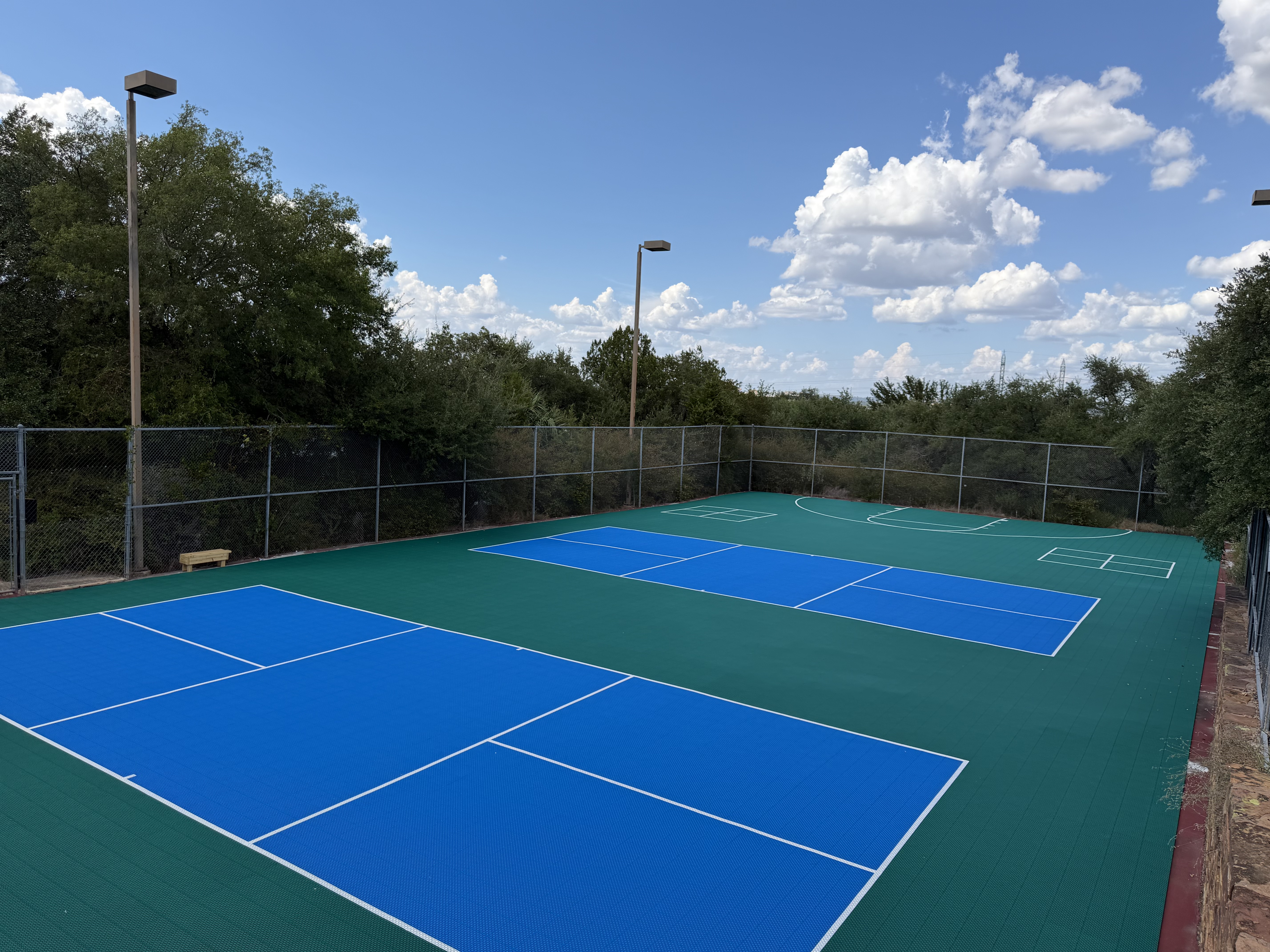 Baycliff Apartments pickleball courts and half basketball court with Hill Country views, Horseshoe Bay TX