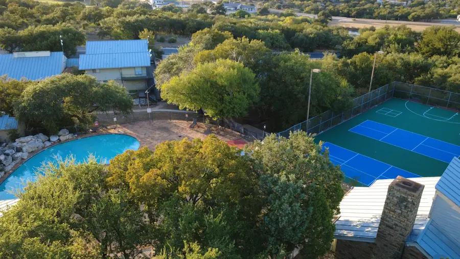 Aerial of Baycliff resort-style pool, stone patio, BBQ pavilion and pickleball courts